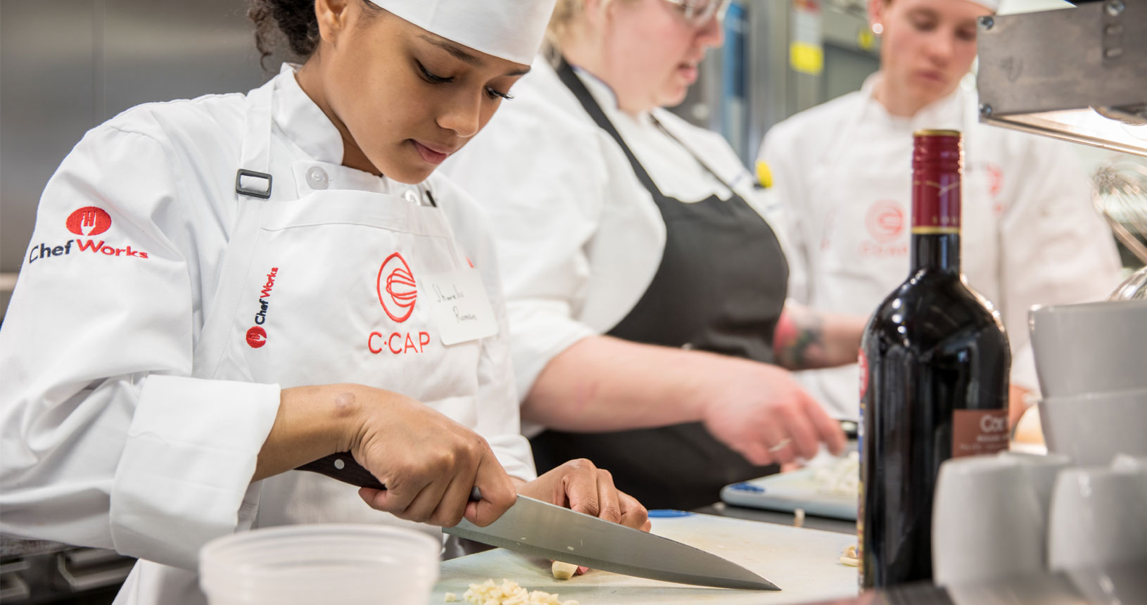 C-CAP student cutting garlic