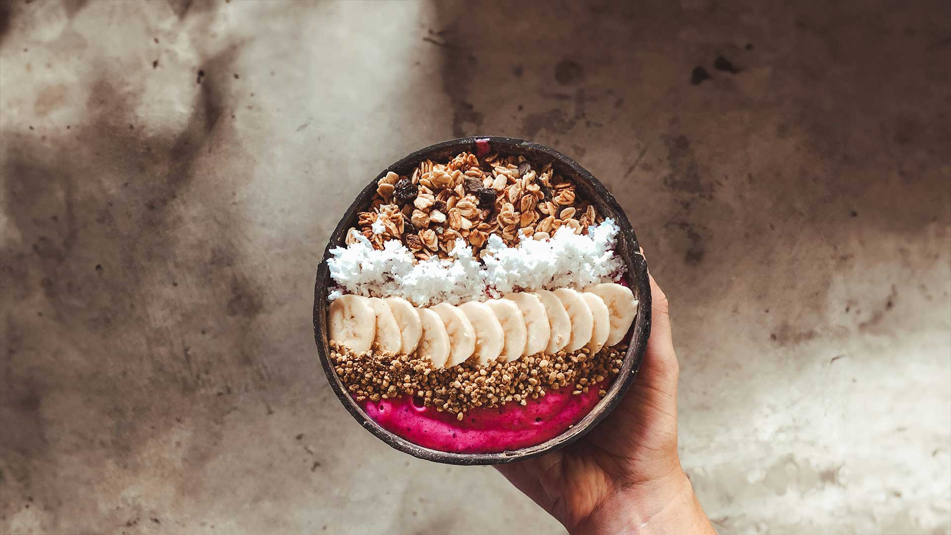 Smoothie bowl held in hand