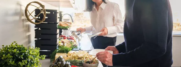 Two office employees making a plate from buffet