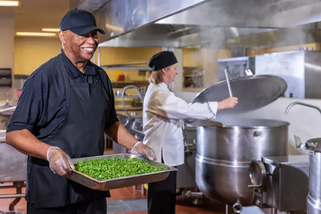 Two Summit employees cooking in kitchen