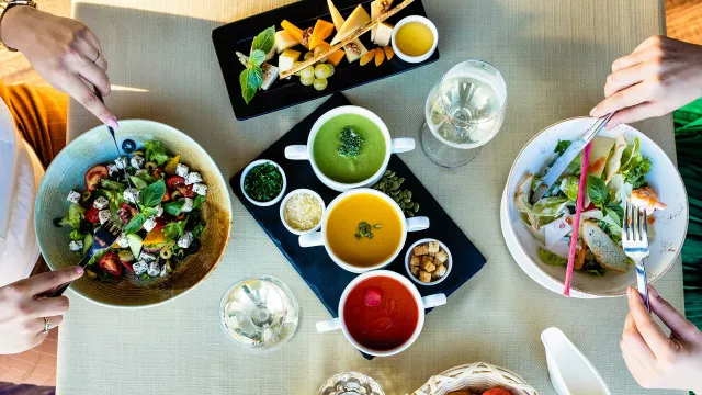 Overhead shot of two people eating salad
