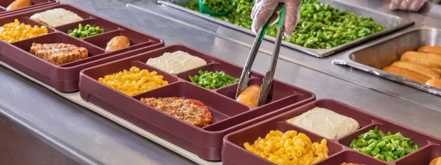 Line of food trays being filled