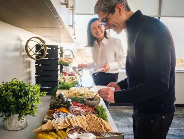 Two office employees making a plate from buffet