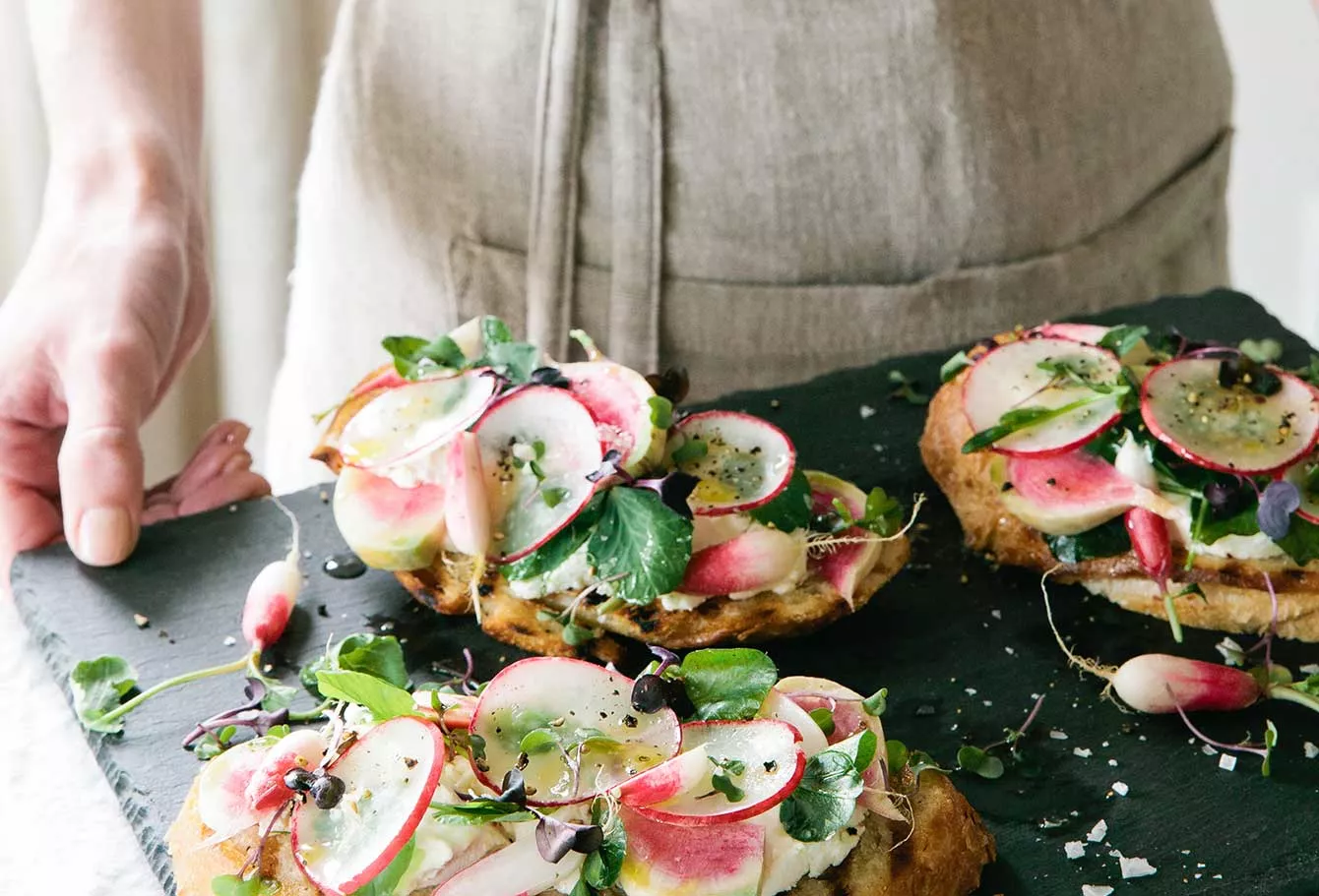 Tray of toast with radishes