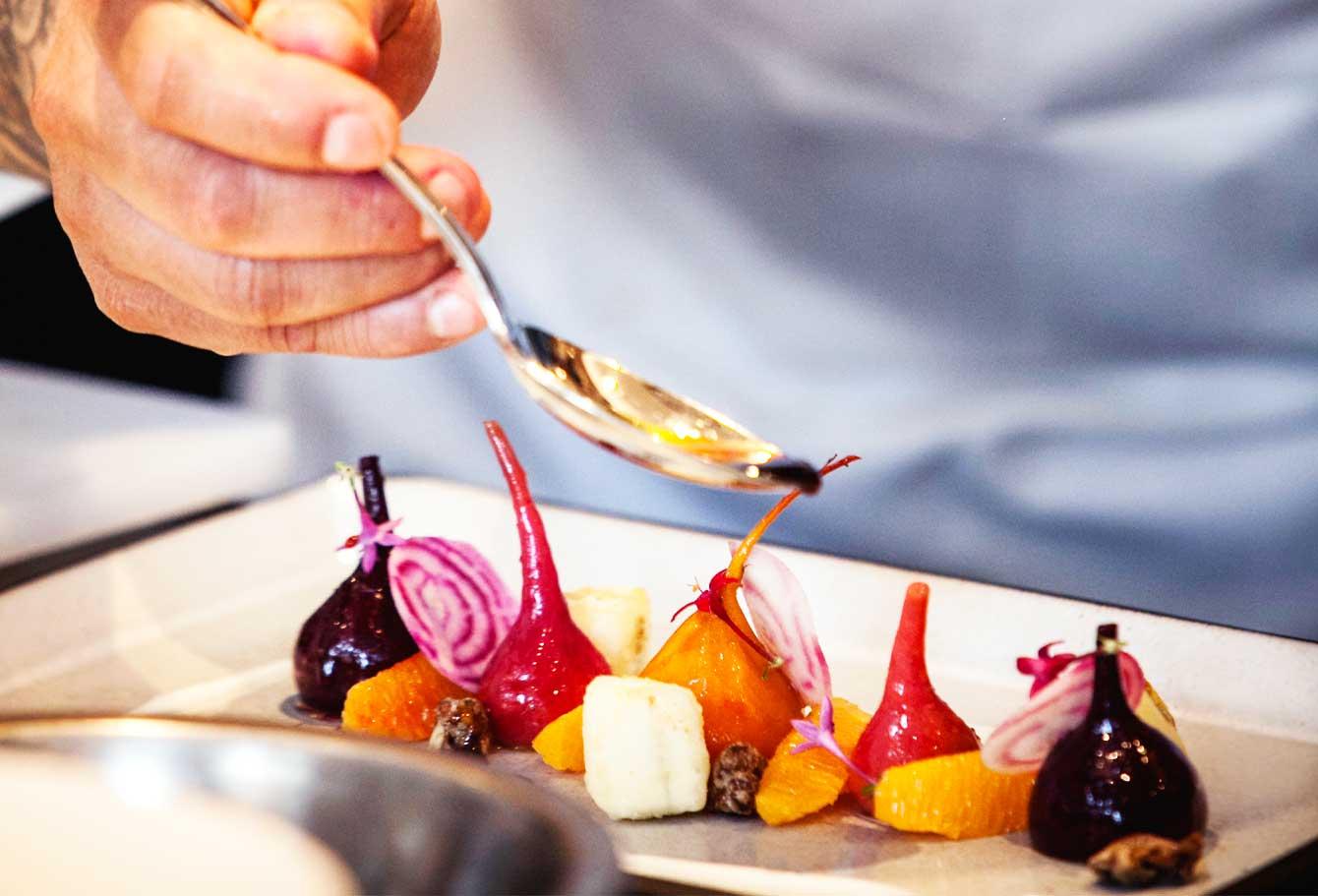 Chef plating dish of roasted beets