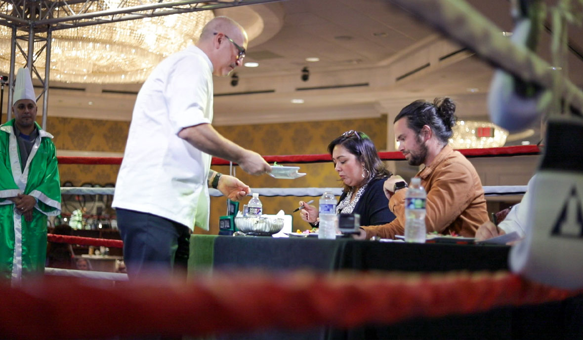 Chef Paul Basciano handing judges dishes