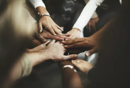 Diverse group of hands together in a circle