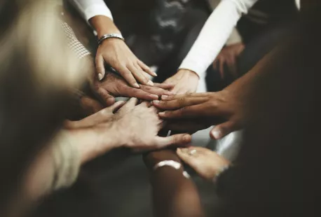 Diverse group of hands together in a circle Diverse group of hands together in a circle