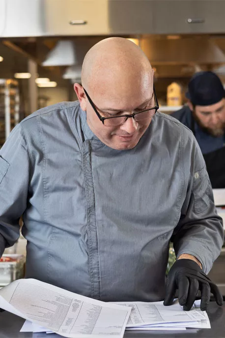 Chef looking down at notes Chef looking down at notes